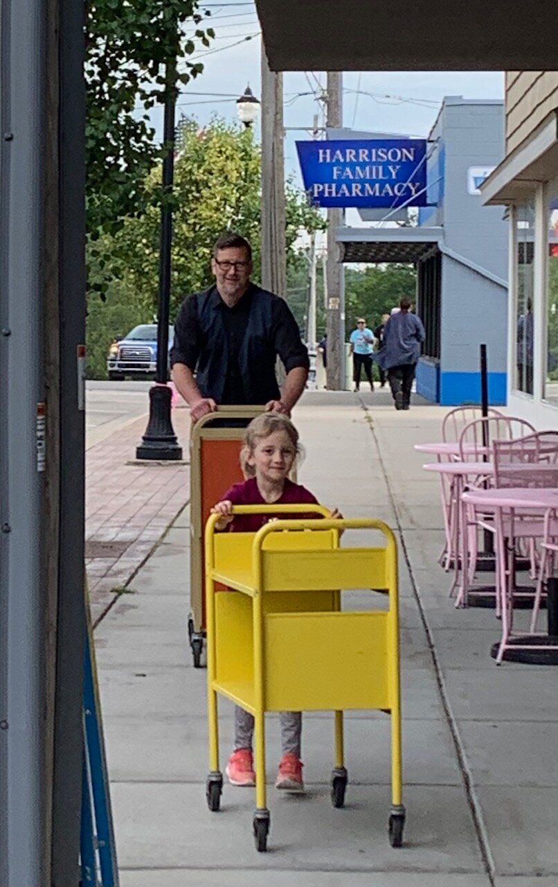 Like grown up, well-educated ants with a purpose, library staff and volunteers hustle their carts full of books and other library materials from the old library building at the corner of Main and Second streets to the new site one block north on Second.
